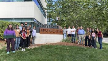 IDeA Lab Group Photo. People on grass in front of office building 
